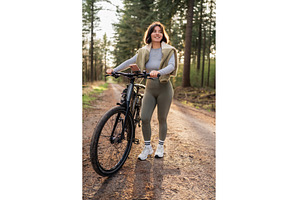 Sporty woman rides forest path on, a Nature Photo by AD Stock Images