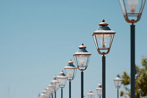 Scenic walkway with vintage street lamps and greenery, a Wallpaper Photo by AlyaAnd