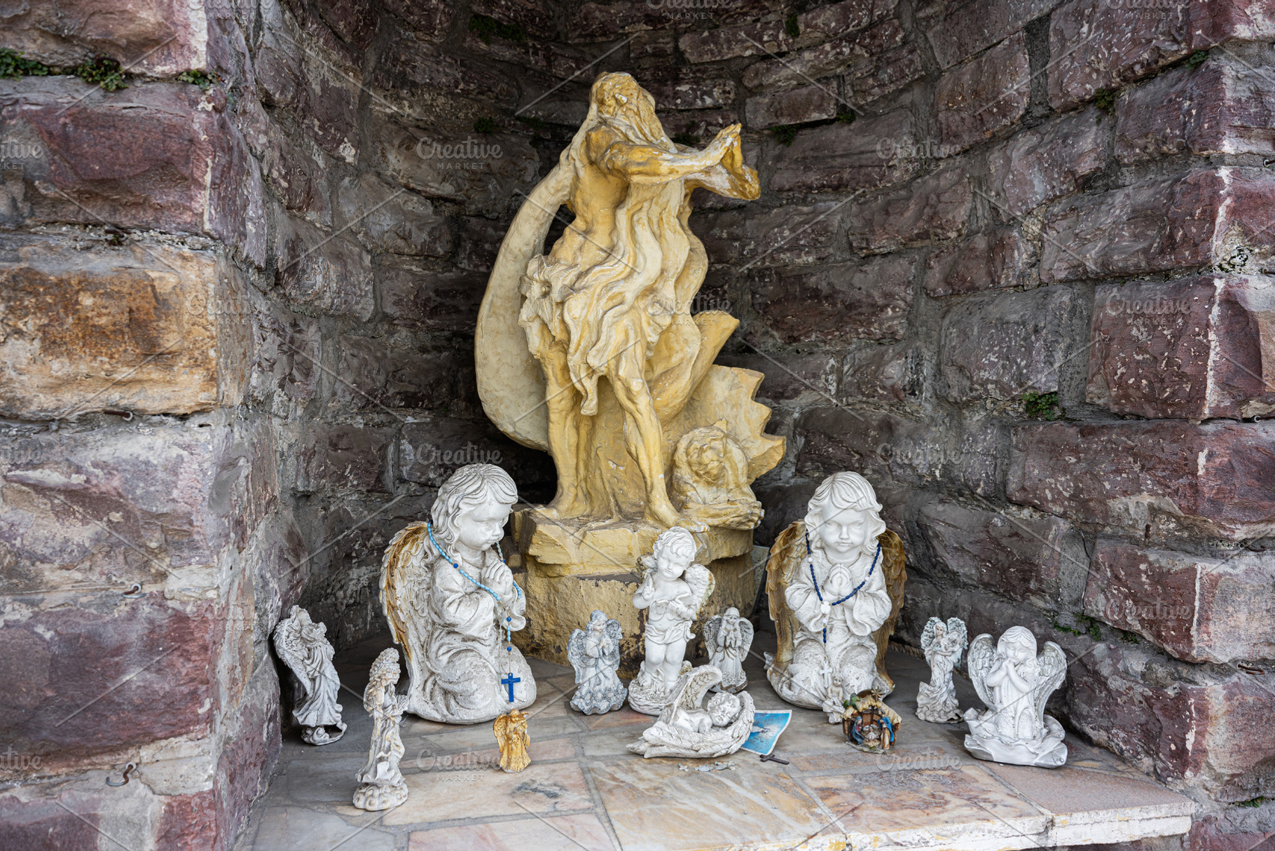 Stone niche with angelic statues and serene spiritual atmosphere, Buchach, Ukra, a Photo by AS photostudio