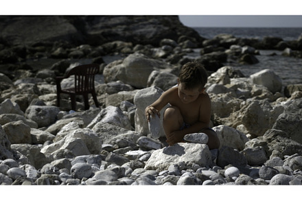 A little boy is playing with rocks, a Person Photo by Media Whale Stock