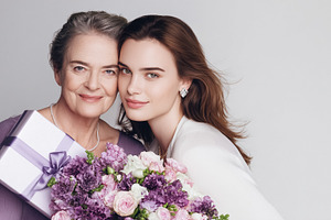 Mother and adult daughter celebrating Mother's Day, hugging with, a Photo by Studio ANNA