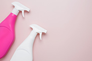 Household cleaning and hygiene concept. Pink and white cleaning supplies spray, a Photo by matucha
