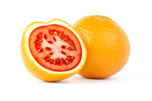 Sliced orange with red tomato inside, a Food & Drink Photo by BOOCYS