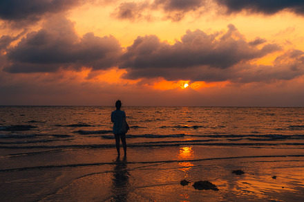 Sunset at sea with orange sky and waves, a Nature Photo by Art Rachen