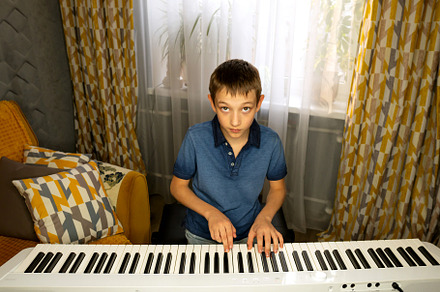 Boy looking up while playing digital, a School & Education Photo by Elena Vagengeim