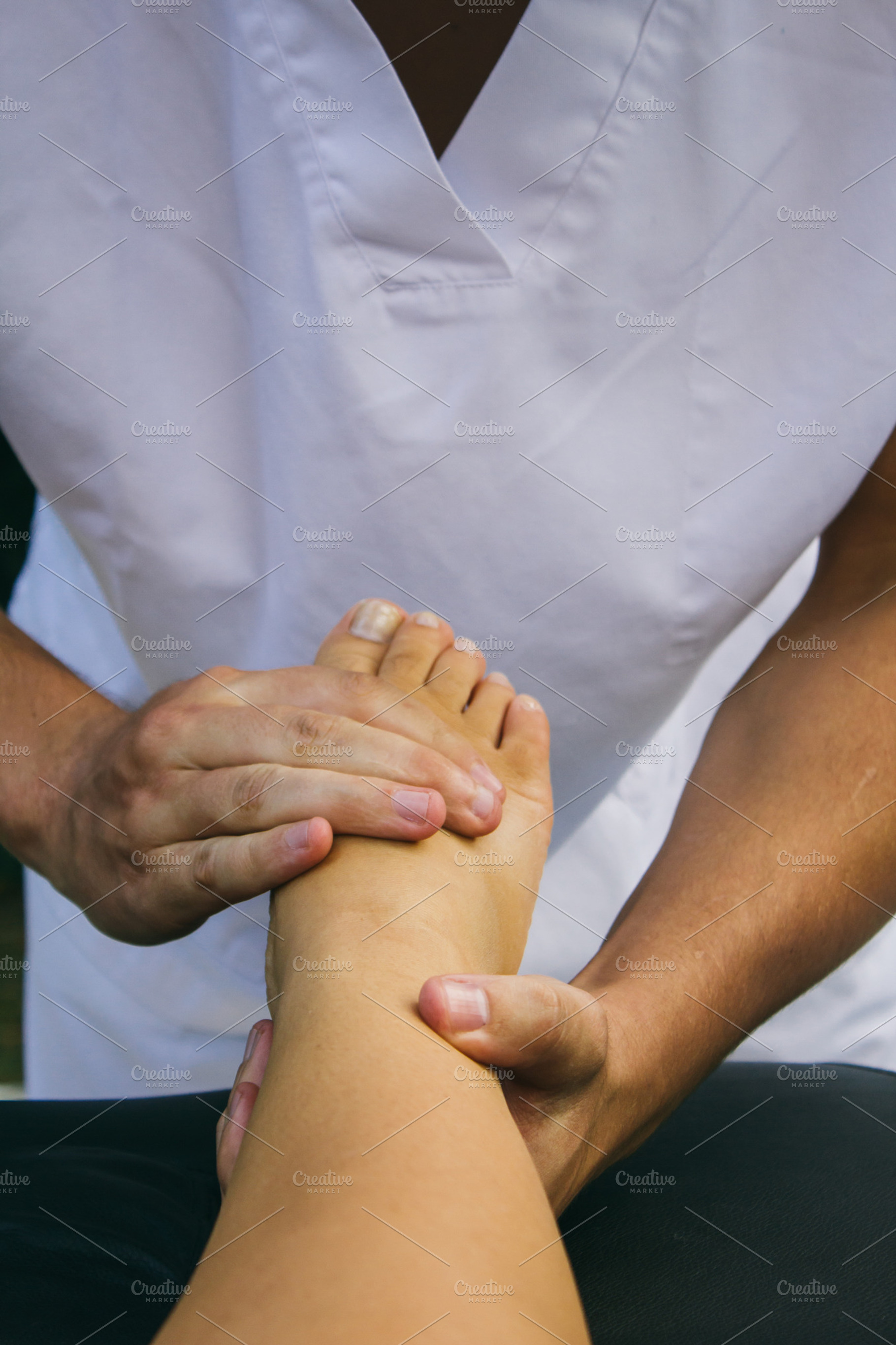 Physiotherapist treating a foot stock photo containing acupressure and body, a Health & Medical Photo by Am.Benitez Estudio