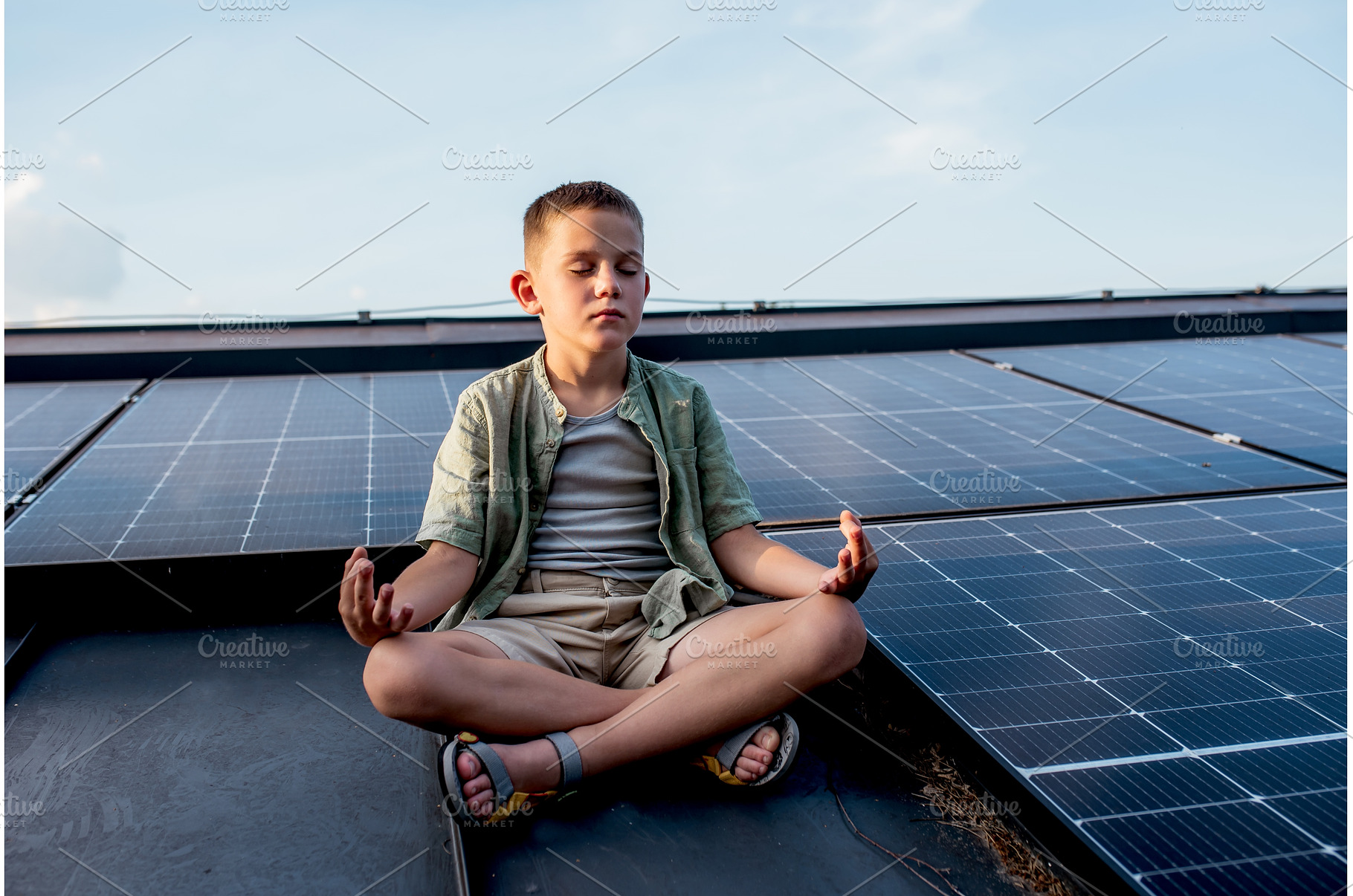 Cute boy sitting on roof with solar, a Technology Photo by HalfPoint