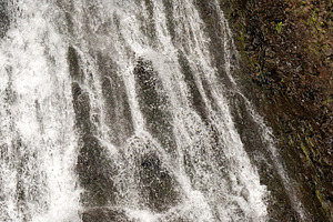 Waterfall flowing over dark rocky, a Nature Photo by Elena Vagengeim
