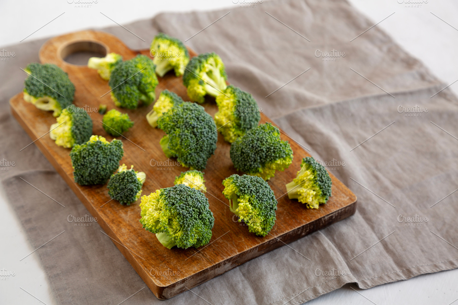 Raw Organic Green Broccoli on a Wooden Board, side view. Copy sp, a Food & Drink Photo by LiudmylaChuhunova
