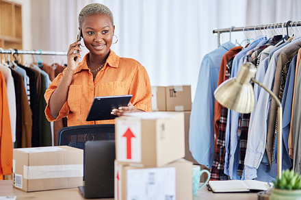 Black woman, phone call and communication in small business of fashion designer for orders at boutique. Happy African female person talking on smartphone with boxes in logistics, courier or delivery, a Photo by Peopleimages.com