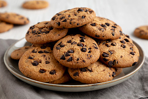 Homemade Chocolate Chip Cookies on a Plate, low angle view. Clos, a Food & Drink Photo by LiudmylaChuhunova