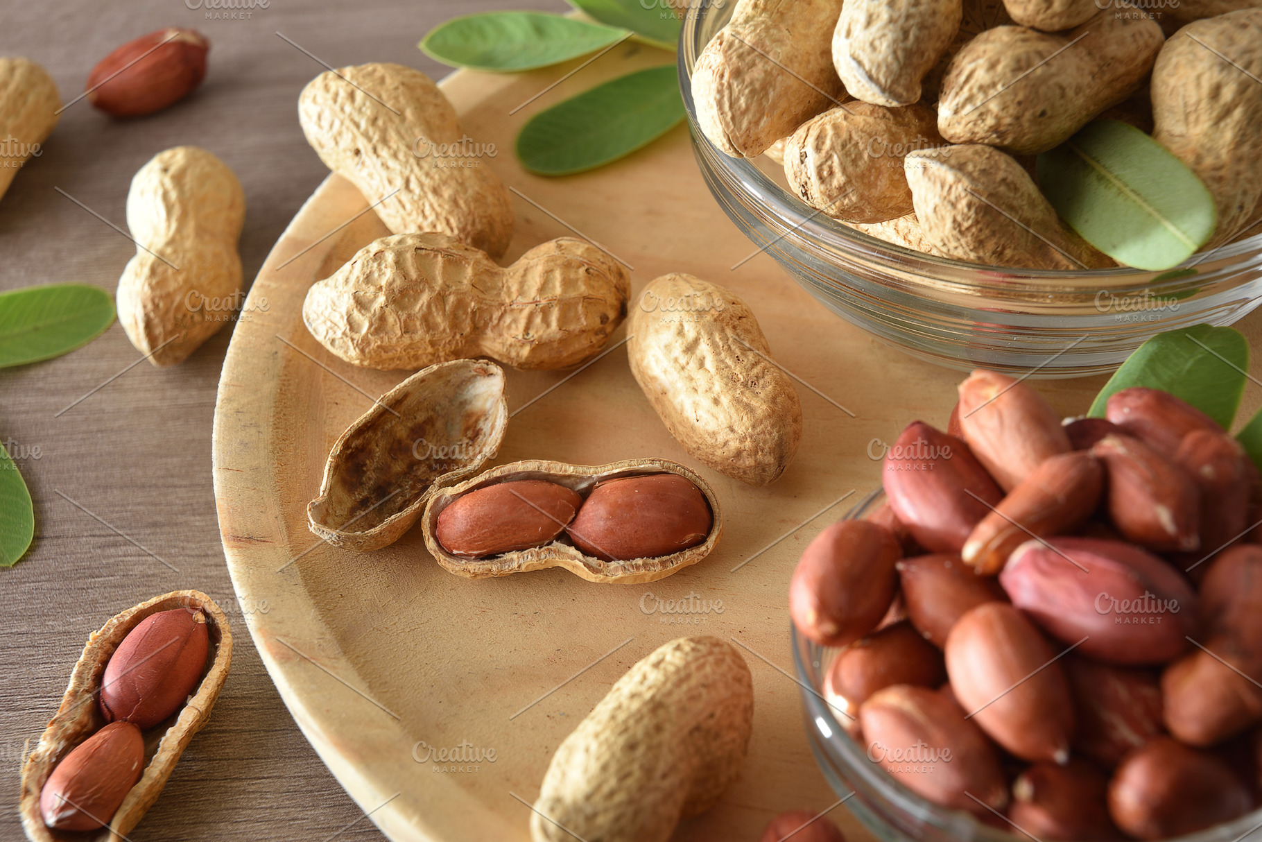 Detail of peanut in bowls on wooden plate elevated view, a Food & Drink Photo by Davizro's Market