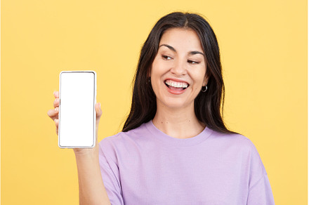 Amazed woman holding a mobile with a, a Technology Photo by Iván Moreno STOCK PHOTO