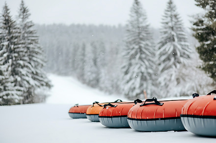 Snow tubing on a snowy hill.