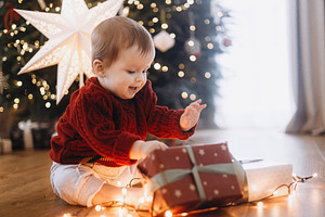 Merry Christmas and Happy Holidays! Cute baby in knitted sweater, a Holiday Photo by Sonjachni