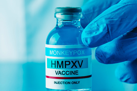 healthcare worker shows vial of monkeypox vaccine, a Photo by Nito