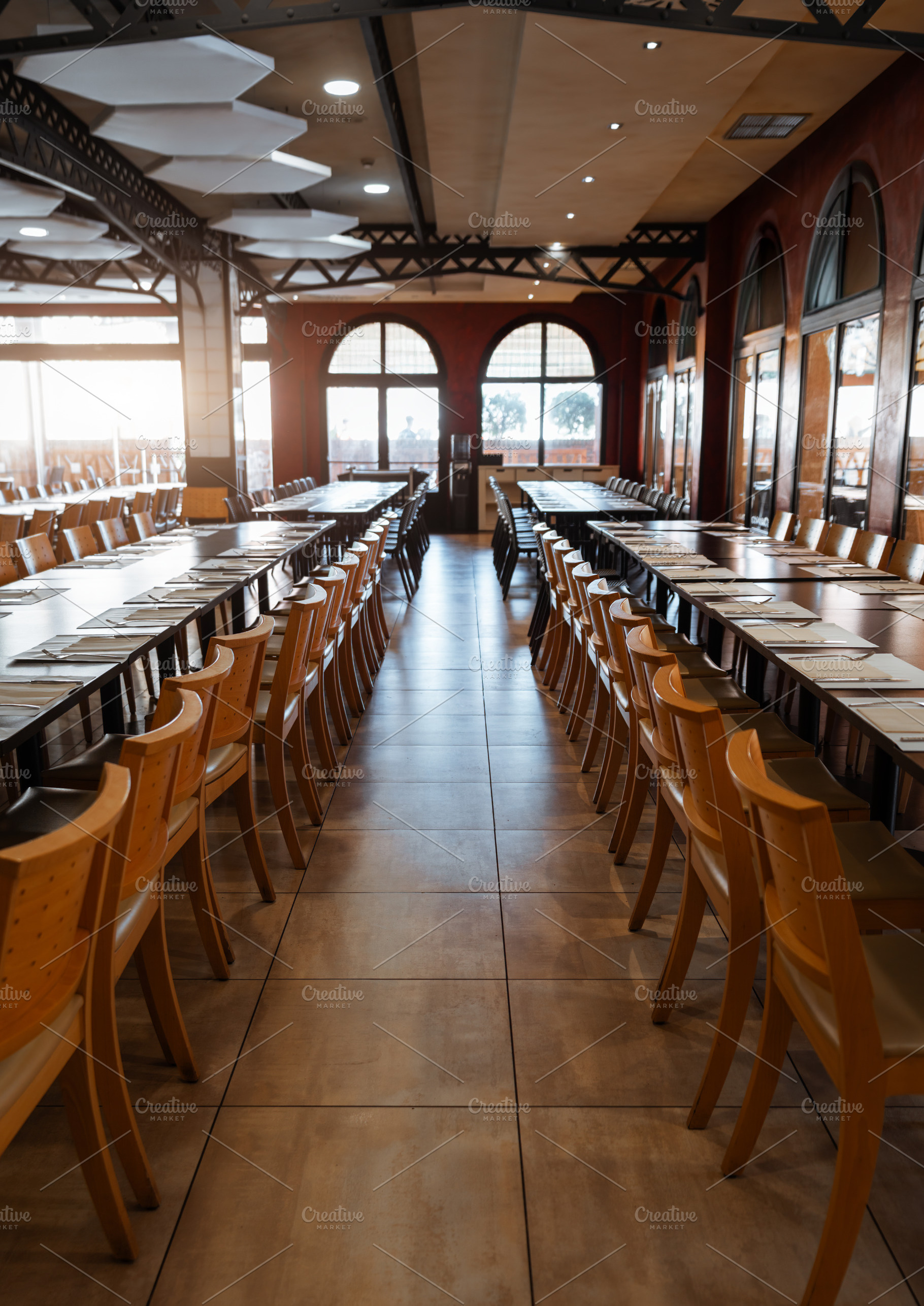 Sunlit banquet hall with tables, a Food & Drink Photo by SkyNext