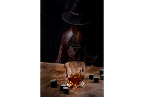 Glass of whiskey and stones, a Food & Drink Photo by Yulia Furman
