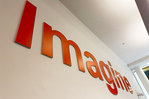 Imagine sign on office wall in Liverpool UK showcasing orange branding and crea, a Photo by AS photostudio