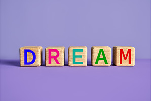 The word DREAM on wooden blocks over, a School & Education Photo by Gladkov photography