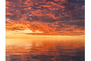 Dramatic sunset reflected in the, a Nature Photo by Backyard Stock