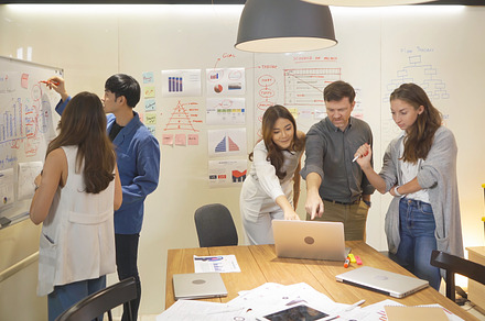 A group of multi ethnic business team talk, communicate, discuss, a Photo by Tampatra