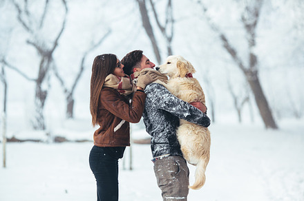 Young couple having fun in winter park featuring activity, adorable, and adult