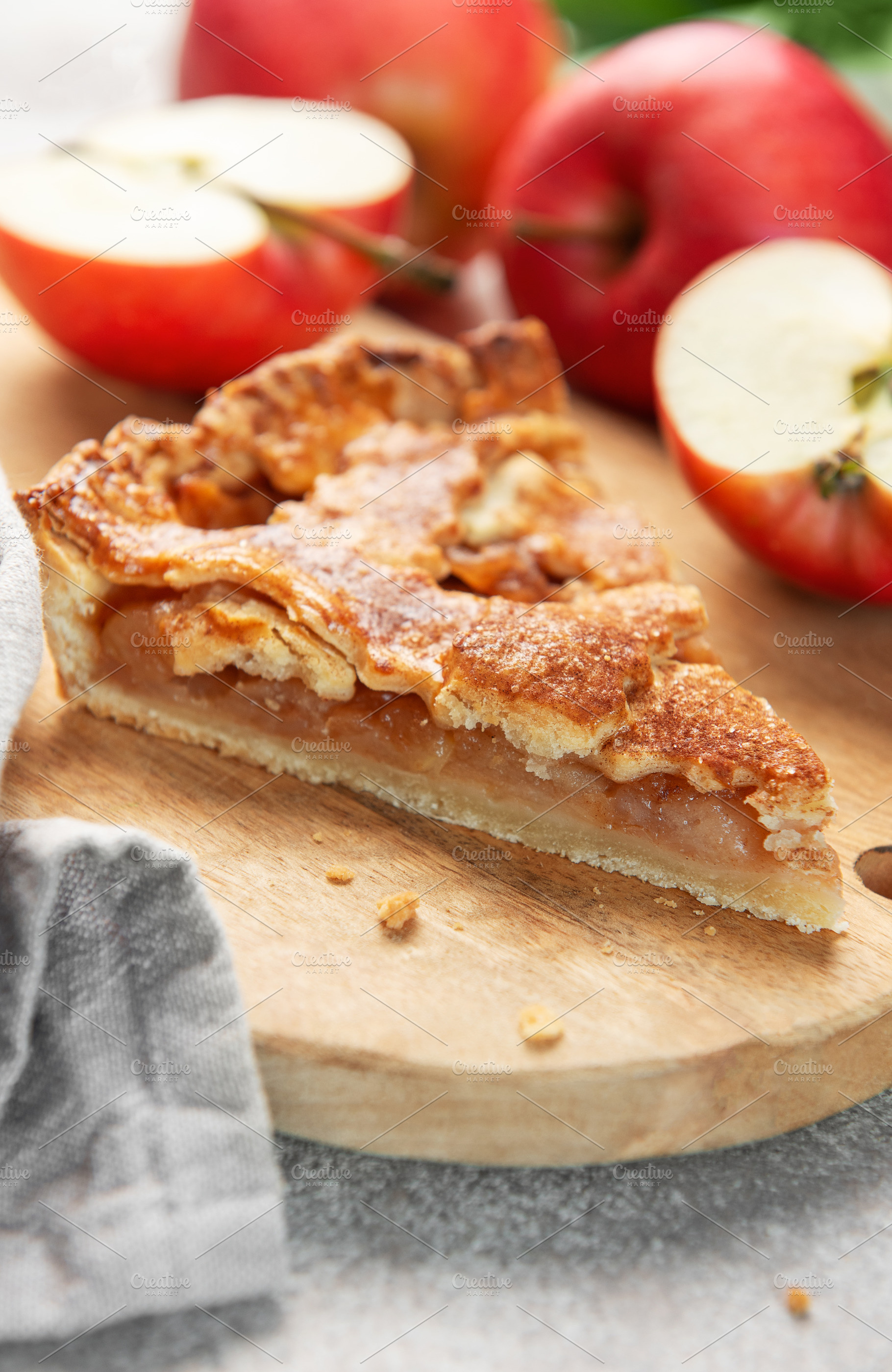 Apple pie slice on wooden board with apples, a Food & Drink Photo by Olena Rudo
