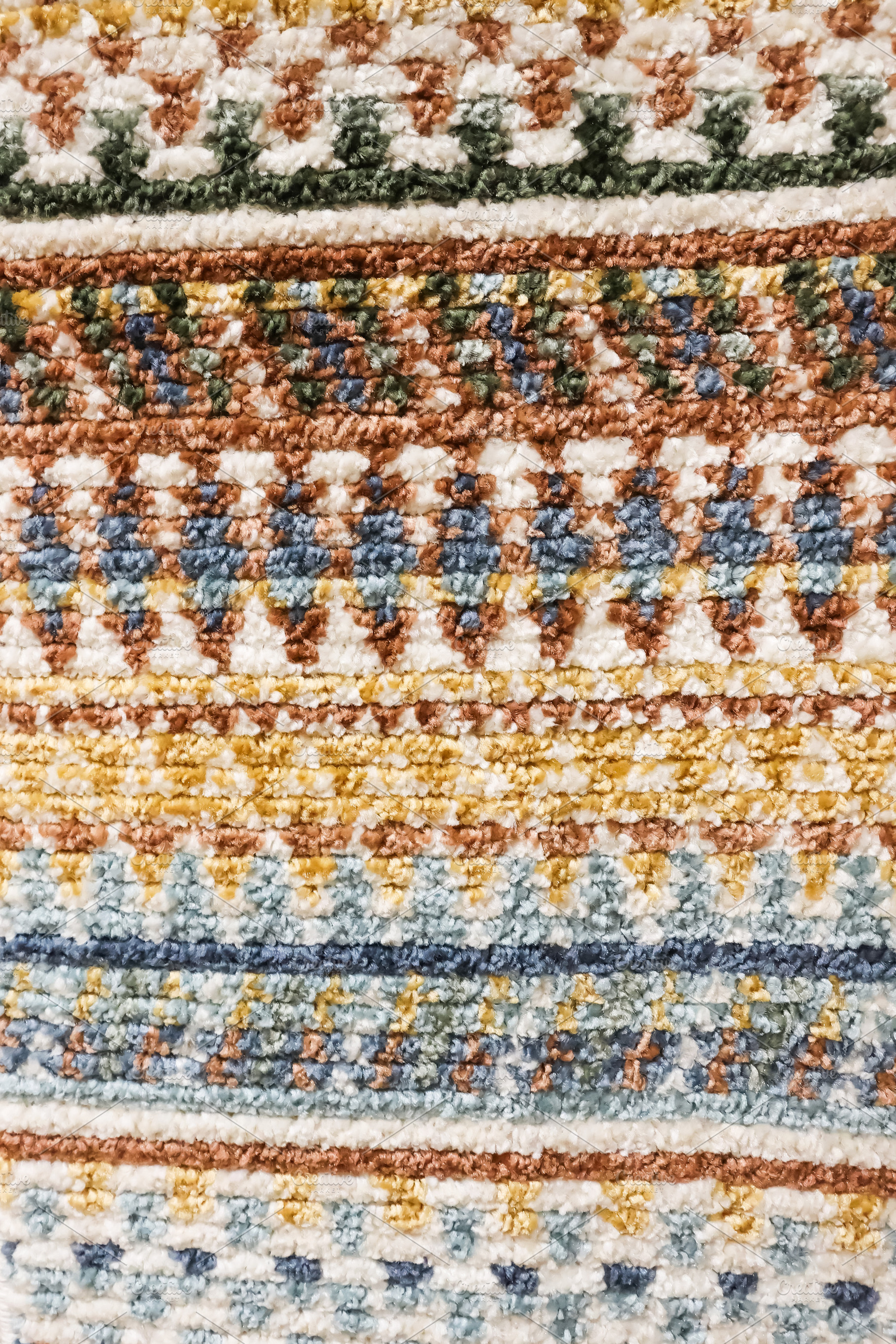 Colorful woven carpet showing intricate bohemian striped pattern and rich texti, a Photo by Studio ANNA