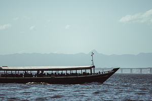 Boat silhouette on open water, a Transportation Photo by SkyNext