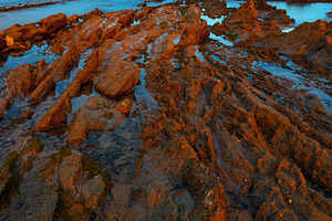 Twilight ocean coast with ribbed stratiform rock., a Nature Photo by YuriyB