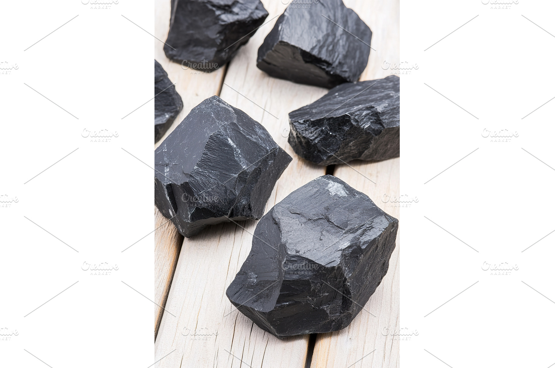 Raw black coal rocks on wooden, a Background Photo by Lermont51