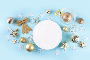 Christmas, New Year table setting with plate, drinking glass, cu