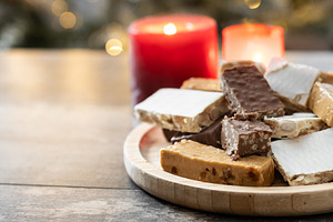 Assorted traditional Christmas nougat on wooden plate, a Food & Drink Photo by etorres69