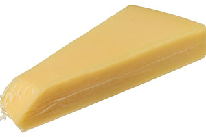 Triangular wedge of smooth, light yellow cheese,  isolated backg, a Food & Drink Photo by ndanko