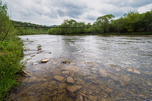 Spring picturesque river band view. Mountains scenery view behin