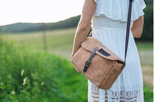 Woman fastening leather strap on, a Person Photo by HalfPoint