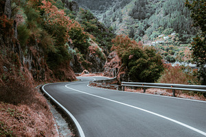 Winding autumn mountain road, a Transportation Photo by SkyNext