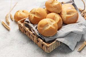 Fresh golden bread rolls in rustic basket, a Food & Drink Photo by Olena Rudo