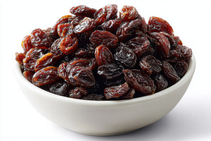 Dark raisins in a white bowl healthy, a Photo by Pixeness Studio