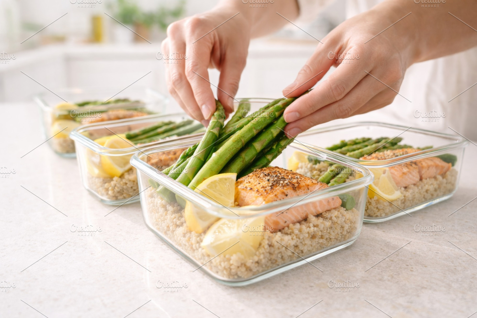 Hands arranging asparagus over salmo, a Photo by Dvoevnore photos