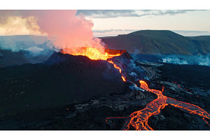Volcanic eruption with lava flow and, a Background Photo by Igor Tichonow