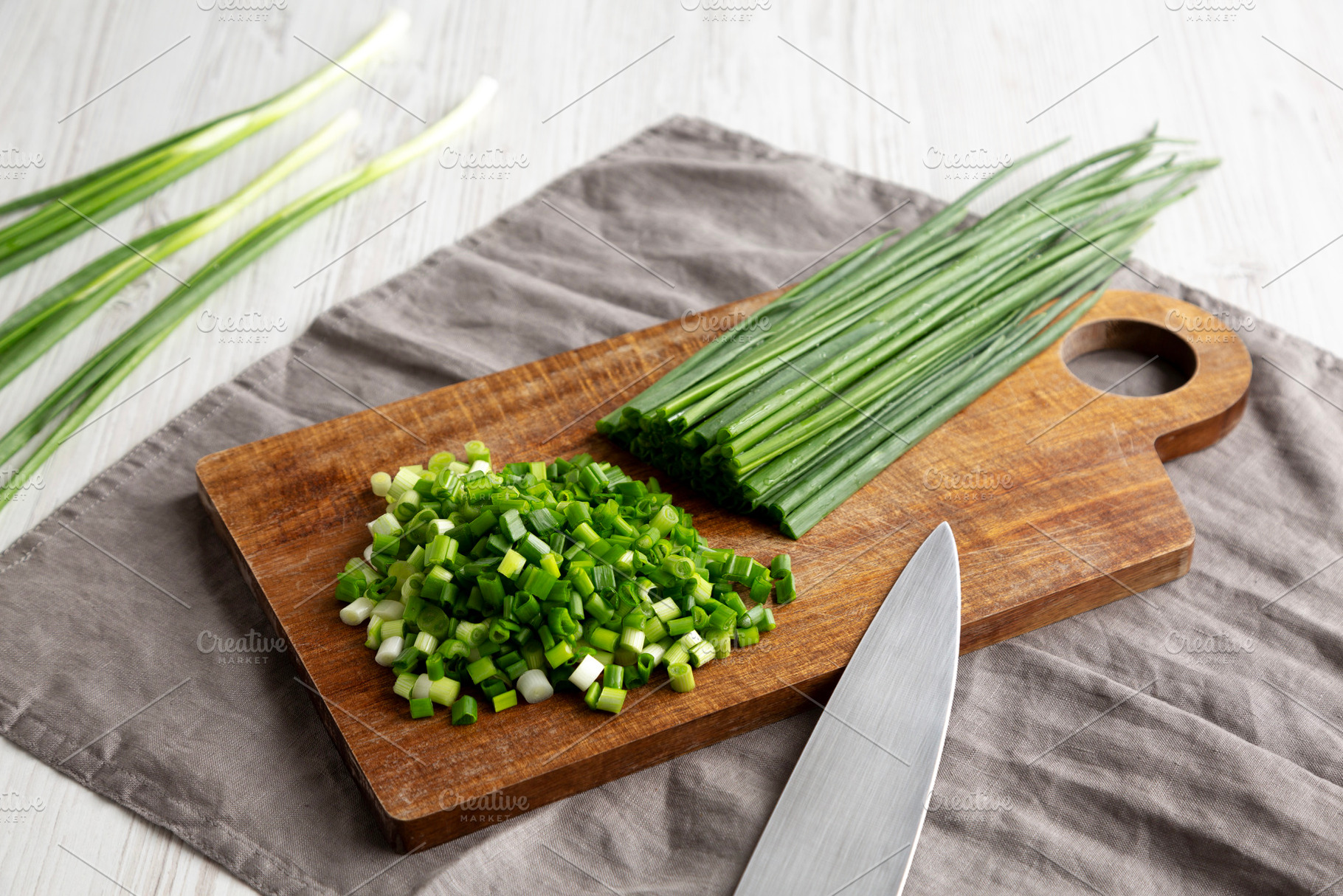 Organic Cut Green Onion Scallions on a Wooden Board, side view., a Food & Drink Photo by LiudmylaChuhunova