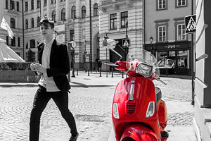Red scooter on Vilnius street, a Transportation Photo by BOOCYS