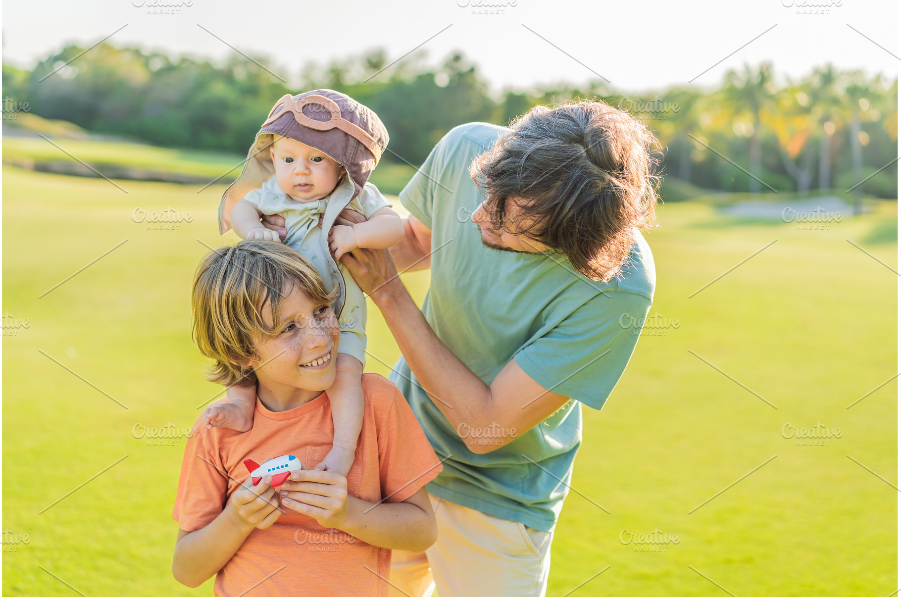 Father, son, and newborn on a meadow, a Person Photo by Elizaveta Galitskaya