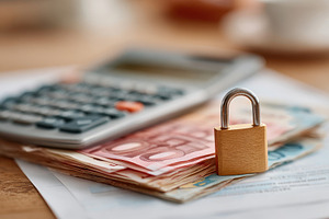 Financial security with calculator and locked cash, a Business Photo by AlyaAnd