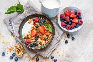 Healthy breakfast granola yogurt bowl with fresh berries, a Food & Drink Photo by Olena Rudo