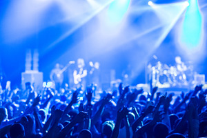 Crowd at concert and blurred stage lights  featuring crowd, people, and event