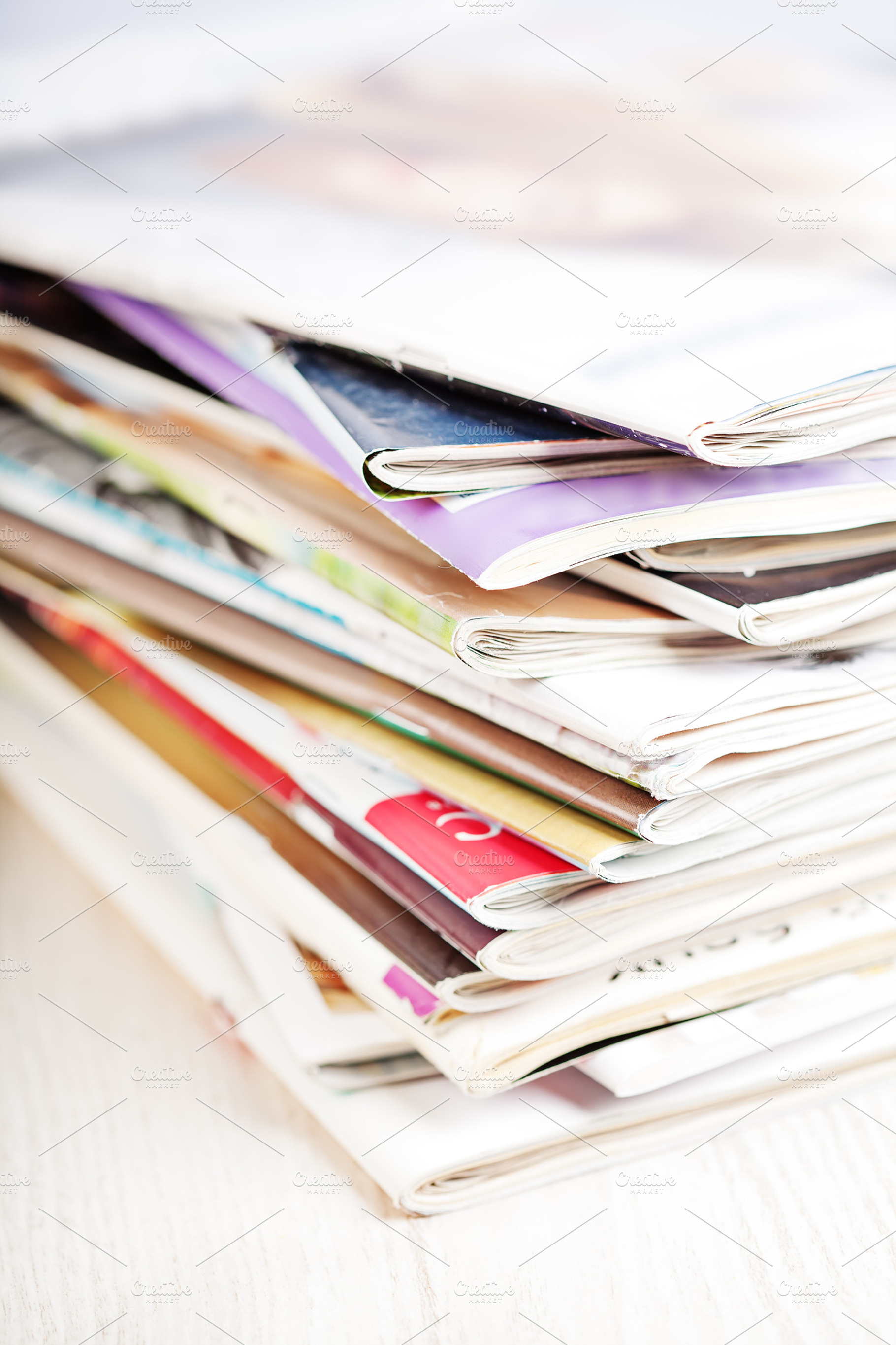 Stack Of Magazines On White Table
