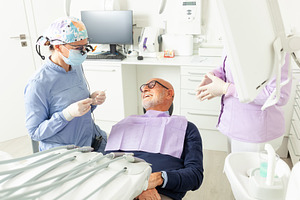 Dentist preparing tools for examining senior man in dental clini, a Photo by Antonio Gravante Market